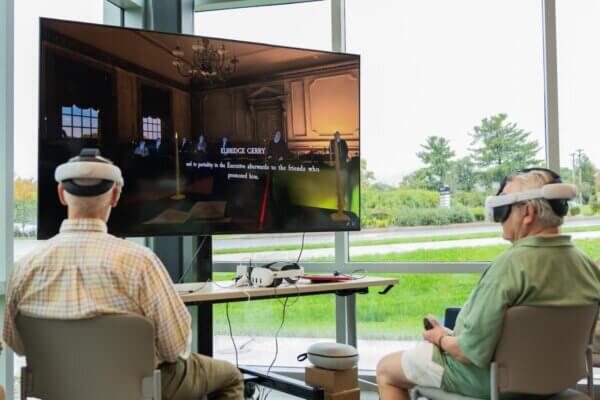 Two individuals participate in "The Great Experiment" virtual reality experience.