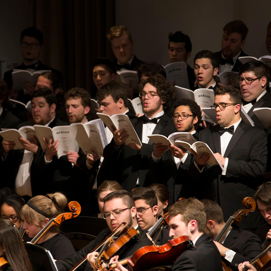 men's chorus and violinists