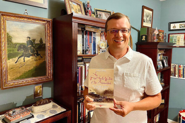 Jonathan Noyalas holds a copy of his new book, "The Blood-Tinted Waters of the Shenandoah."