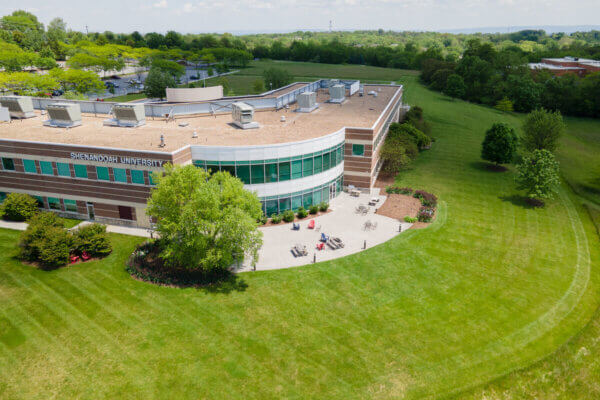 Exterior of Health Professions building, facing a wall lined with windows