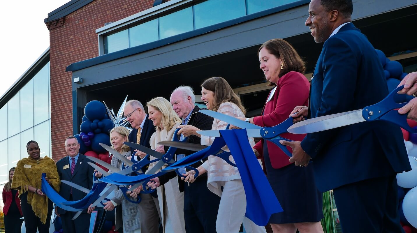 Shenandoah University officials; Cecil Pruitt, Jr.; and members of the Hazel family cut a ribbon to celebrate the opening of Hazel-Pruitt Armory.