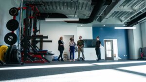 People stand inside a fitness space in Shenandoah University's new Wilkins Health & Fitness Suite.