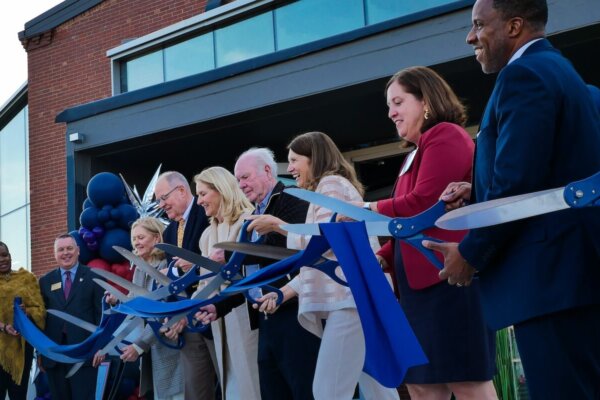 Shenandoah University officials; Cecil Pruitt, Jr.; and members of the Hazel family cut a ribbon to celebrate the opening of Hazel-Pruitt Armory.