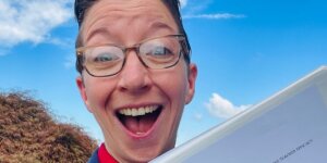 Shenandoah University Ph.D. in educational leadership student Annmarie Noonan '24, holding her award-winning dissertation.