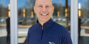 Dr. Craig Richard stands outside of a building