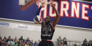 Harlem Globetrotters player Bulldog Mack dunks a basketball.