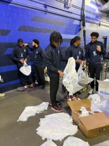 Shenandoah University students help unpack prize parachutes.